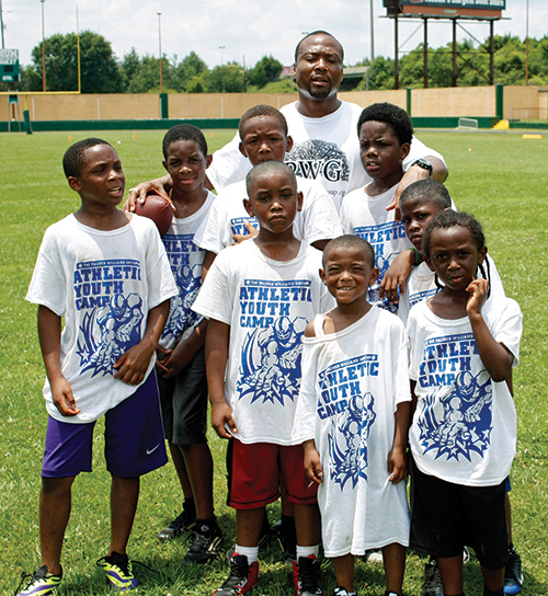 Former Crimson Tide and Dallas Cowboys running back Sherman Williams with participants in an athletic youth camp held in his hometown of Prichard.