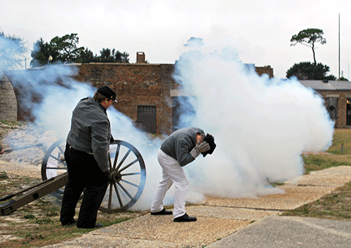 Confederate Army reenactors fire a cannon at Fort Gaines.