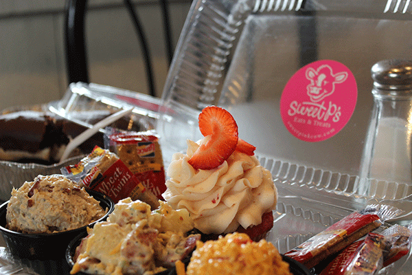 The "Happy Plate" features a scoop of pimento cheese, chicken salad, potato salad, and finishes with a cupcake. 