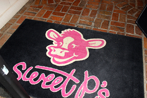 The entrance to Sweet P's showcases the namesake of the restaurant, a pink cow. 