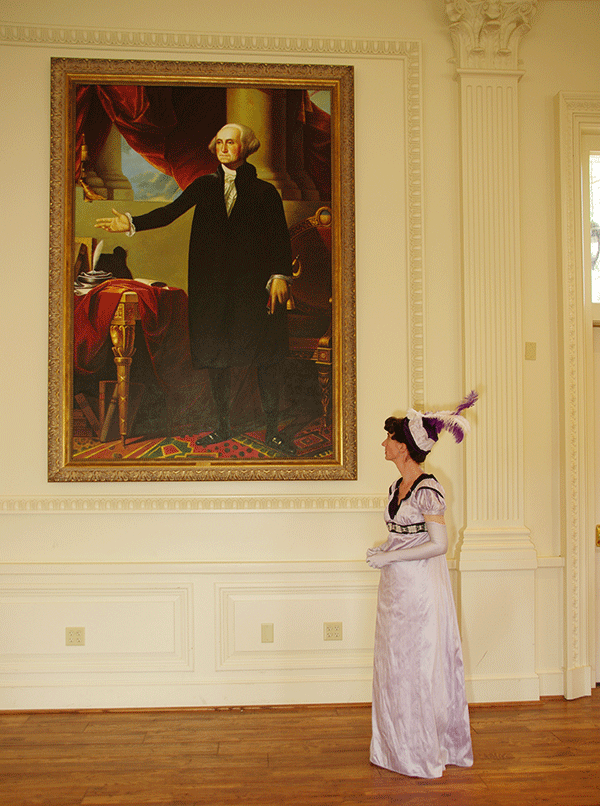 The historical interpreter portraying Dolley Madison gazes upon a reproduction of the portrait of George Washington that she was responsible for saving during the War of 1812.