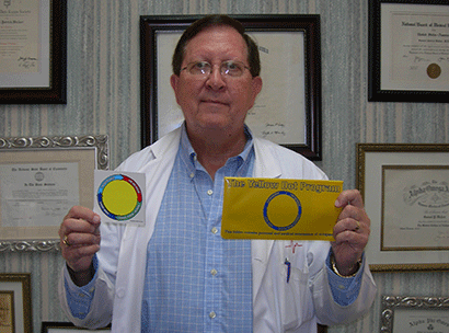 Dr. Pat Walker holds the Yellow Dot decal and packet that contains vital patient information.