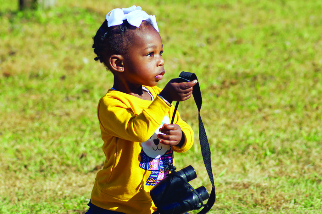 Binoculars aren’t required for birdwatching, but they do help bring the details and beauty of birds into sharper focus for birders of all ages, including Summer Grace Joe, daughter of Connecting with Birds and Nature Tours’ owner Christopher Joe. Photo by Christopher Joe