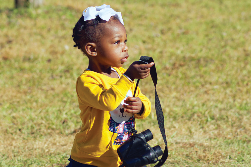 Binoculars aren’t required for birdwatching, but they do help bring the details and beauty of birds into sharper focus for birders of all ages, including Summer Grace Joe, daughter of Connecting with Birds and Nature Tours’ owner Christopher Joe. Photo by Christopher Joe