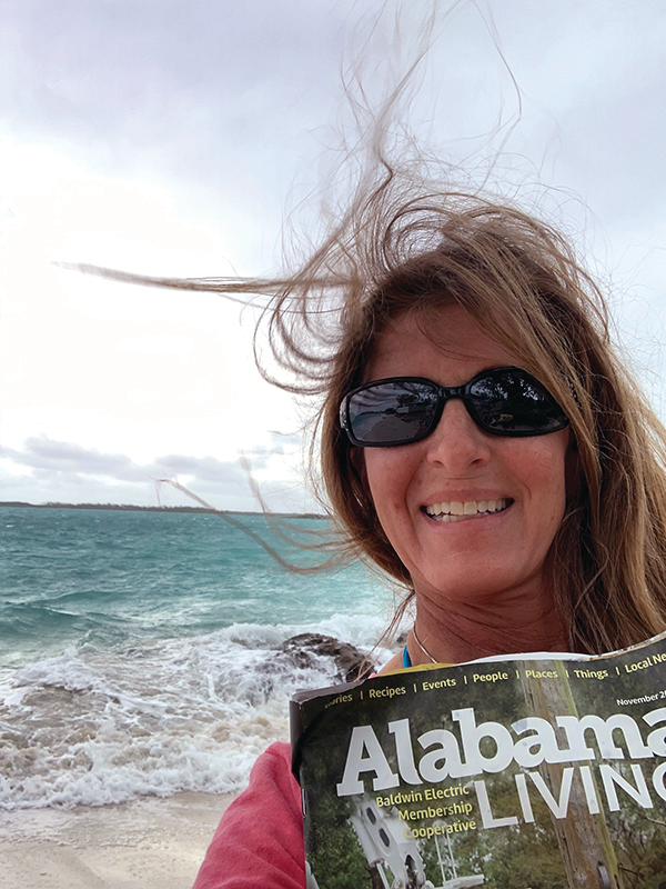 Kimberly Ramsey, a member of Baldwin EMC, braved the winds at Jolly Beach, outside Georgetown in Exuma, the Bahamas. “It was an extremely windy day with gusts up to 45 mph,” she wrote. “I was trying to read my magazine and saw the part about taking a picture of it on your vacation.”