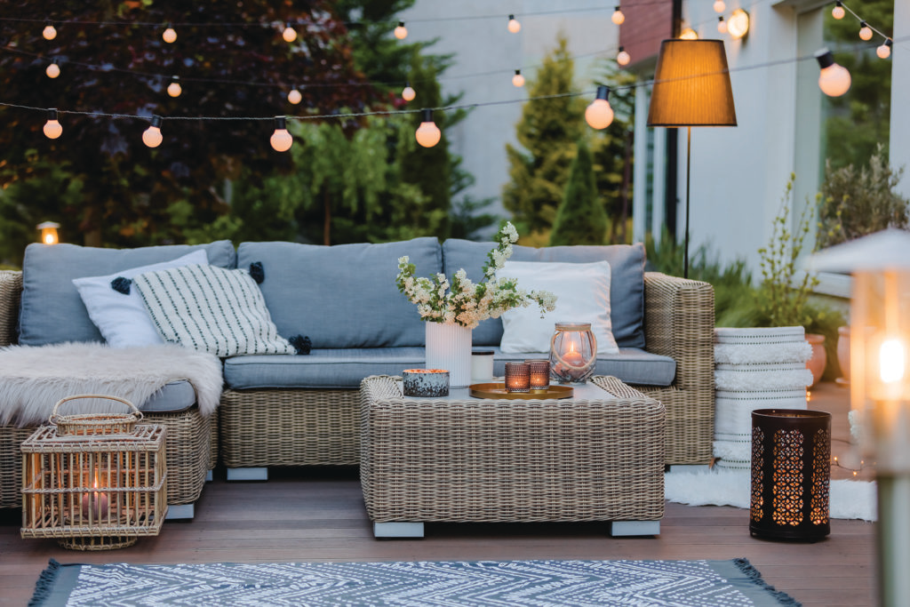 Summer evening on the patio of beautiful suburban house with garden