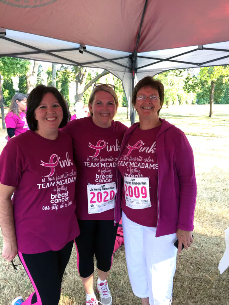 Three women standing as cancer survivors.