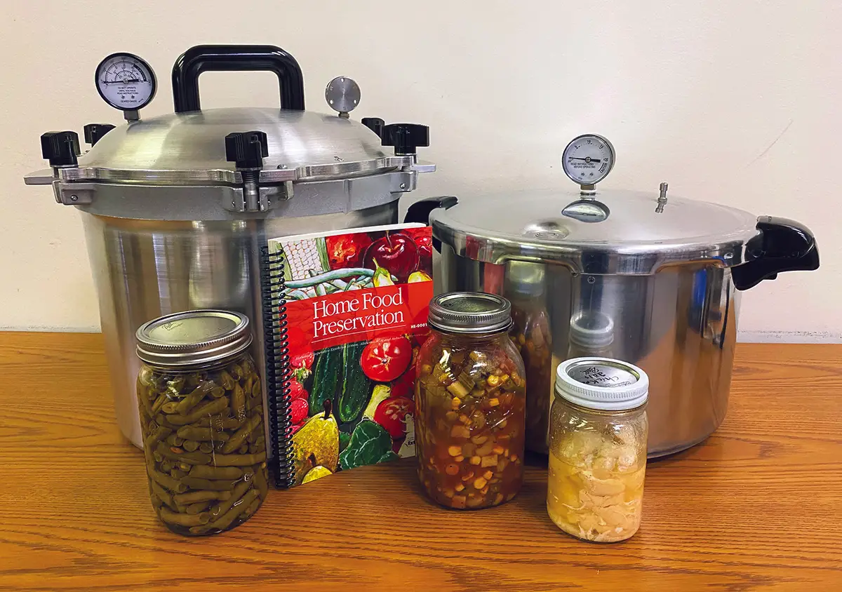 Food supplies for canning and storing of food, pressure cooker, mason jars, cookbook