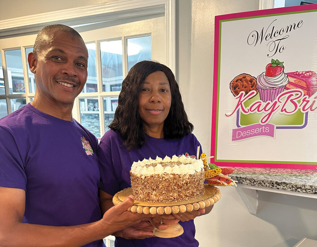 Quinton and Joni Harris, holding one of Joni’s fresh baked carrot cakes, make customer service a priority.                                    PHOTO BY LENORE VICKREY