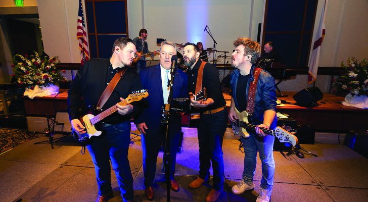 Speaker Ledbetter sings with the Boys in the Band, an Alabama tribute band, at a reception following his investiture. 		         Photo by David Robertson
